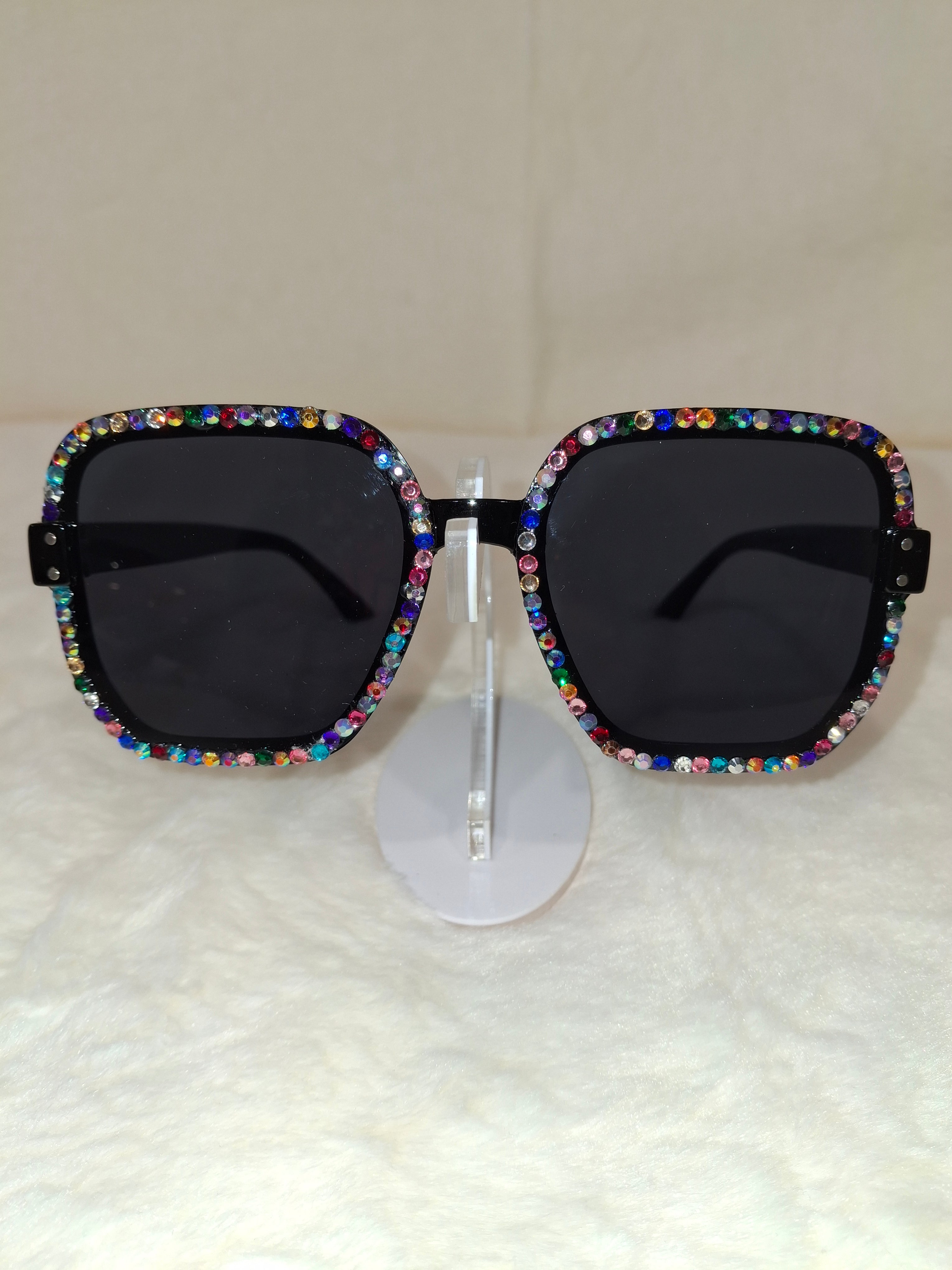 Sunglasses with multicolor rhinestone embellishments on a white background