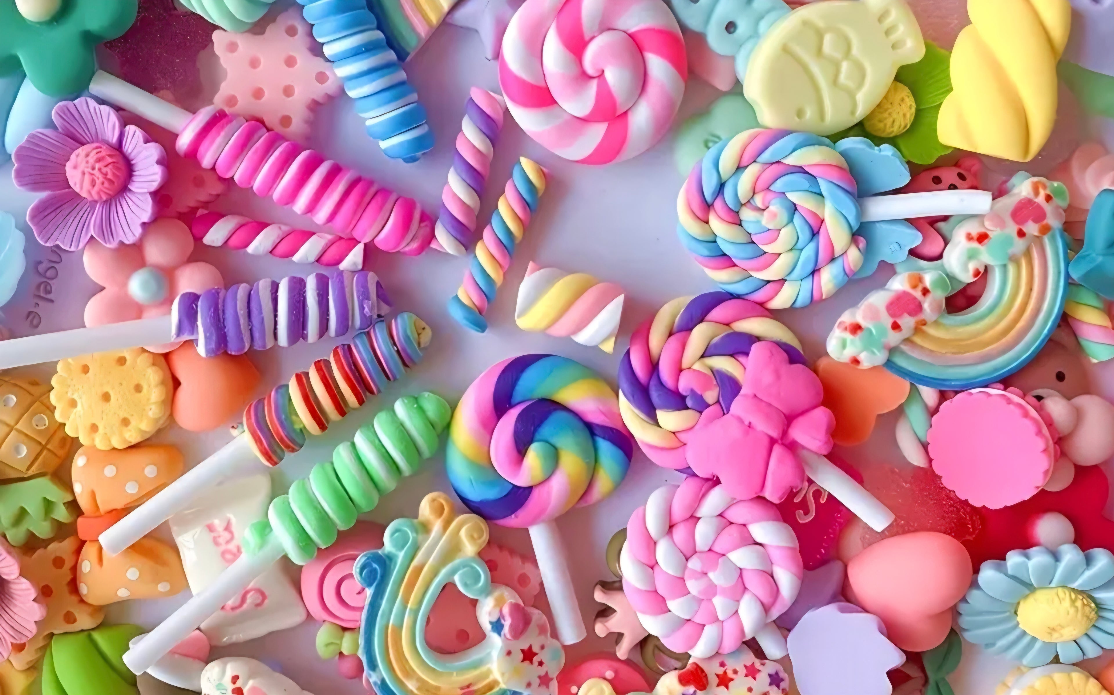 Colorful assortment of candy-themed decorative charms on a white background