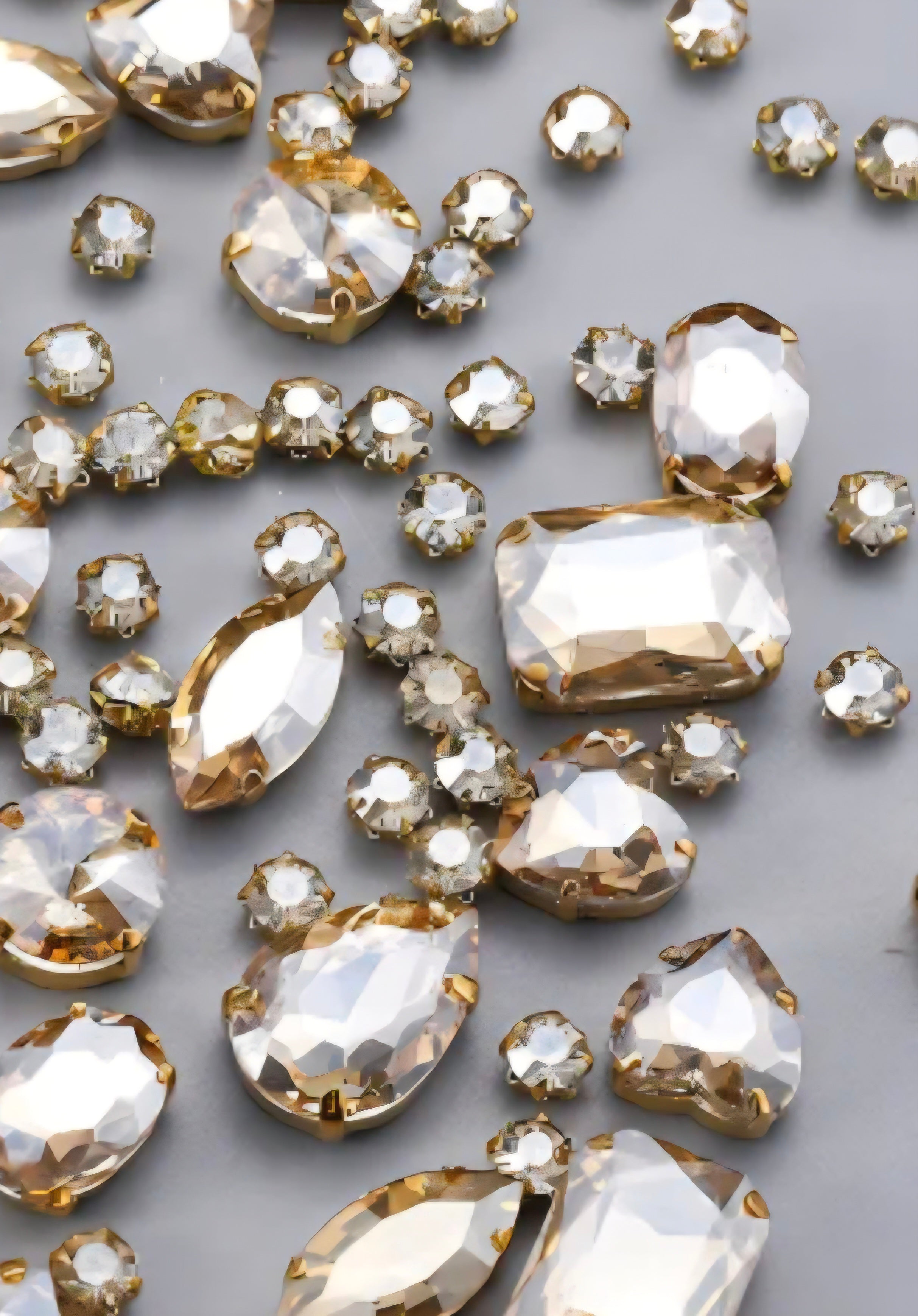 Collection of gemstones in a clear champagne color on a light gray background