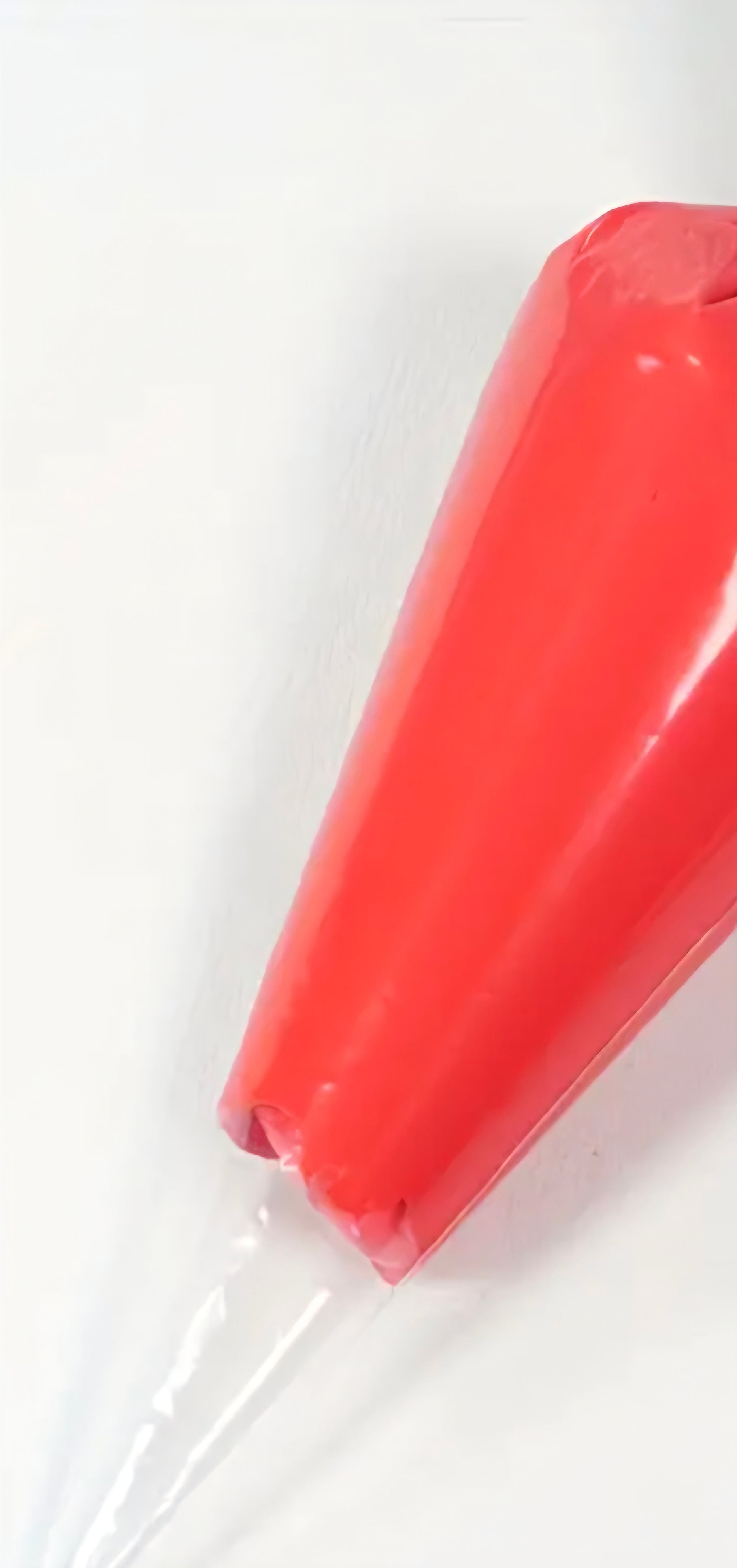 Red decoden cream glue tube on a white background