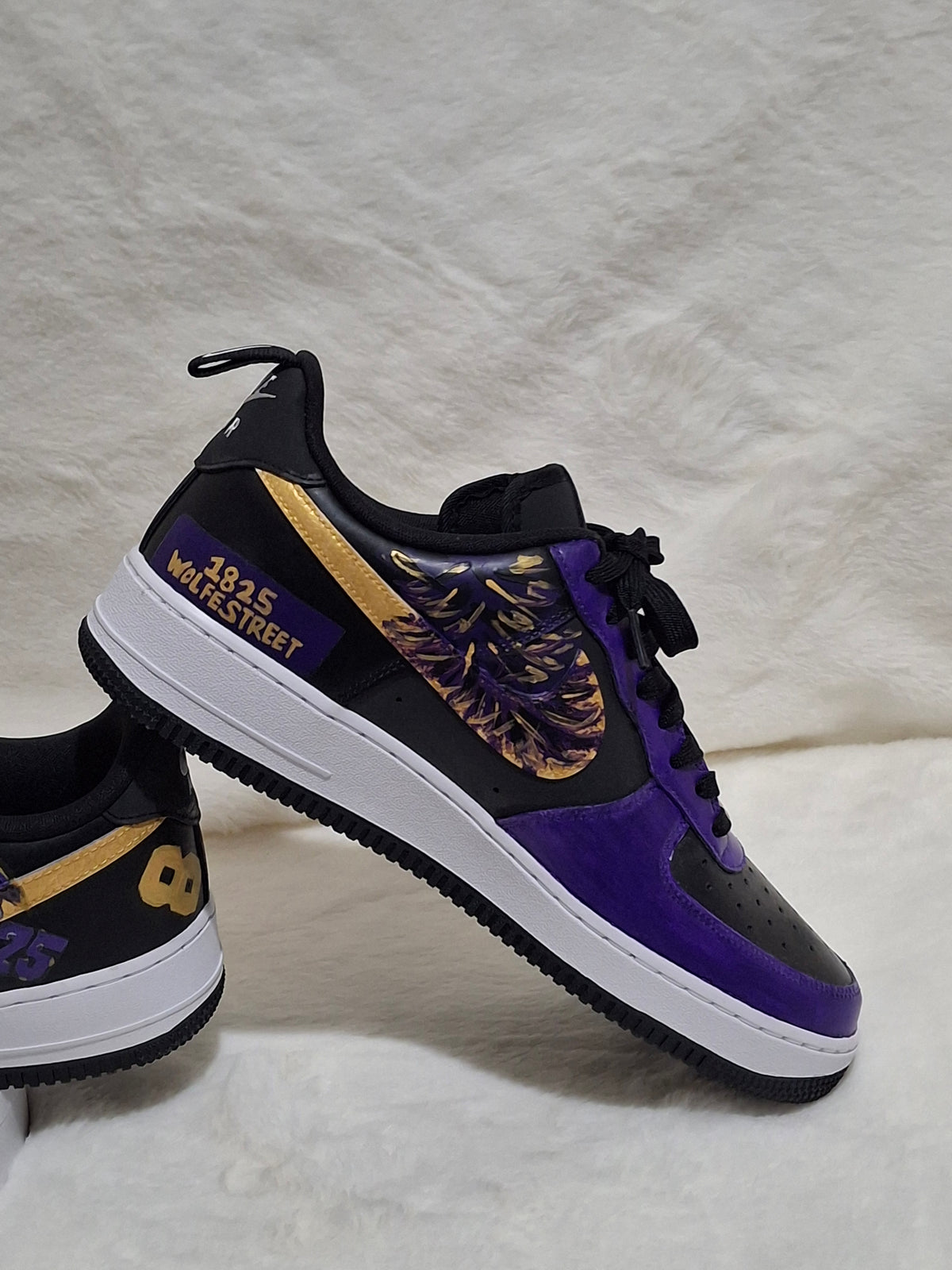 Side view of custom Nike Air Force 1 sneaker featuring purple panels, gold accents and personalized sports theme artwork. 