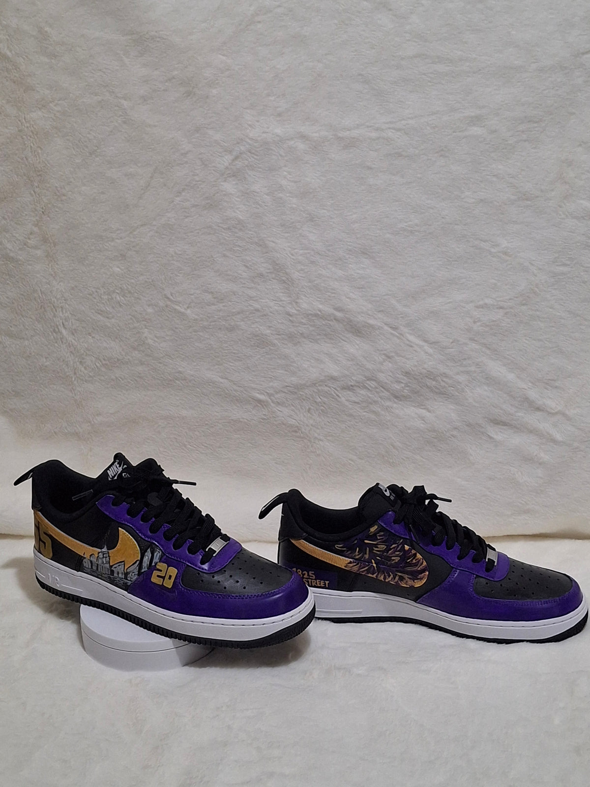 Pair of custom hand-painted Nike Air Force 1 Sneaker shown side by side, featuring coordinating purple and gold artwork.