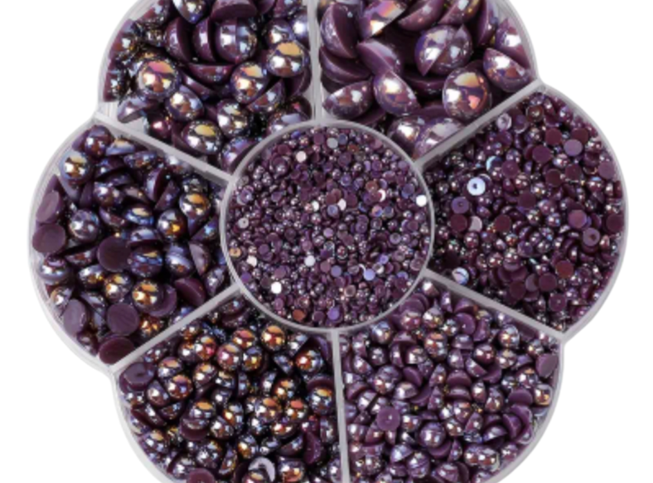 Collection of purple pearls in various sizes on a white background