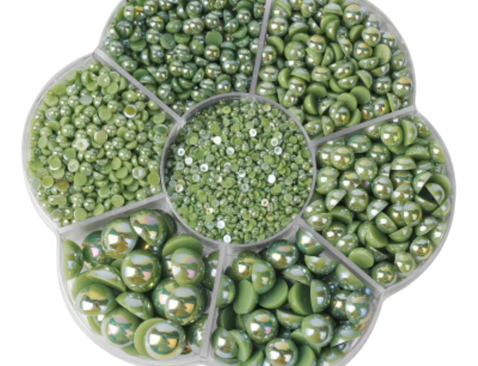 Assorted green pearls in a circular organizer on a white background