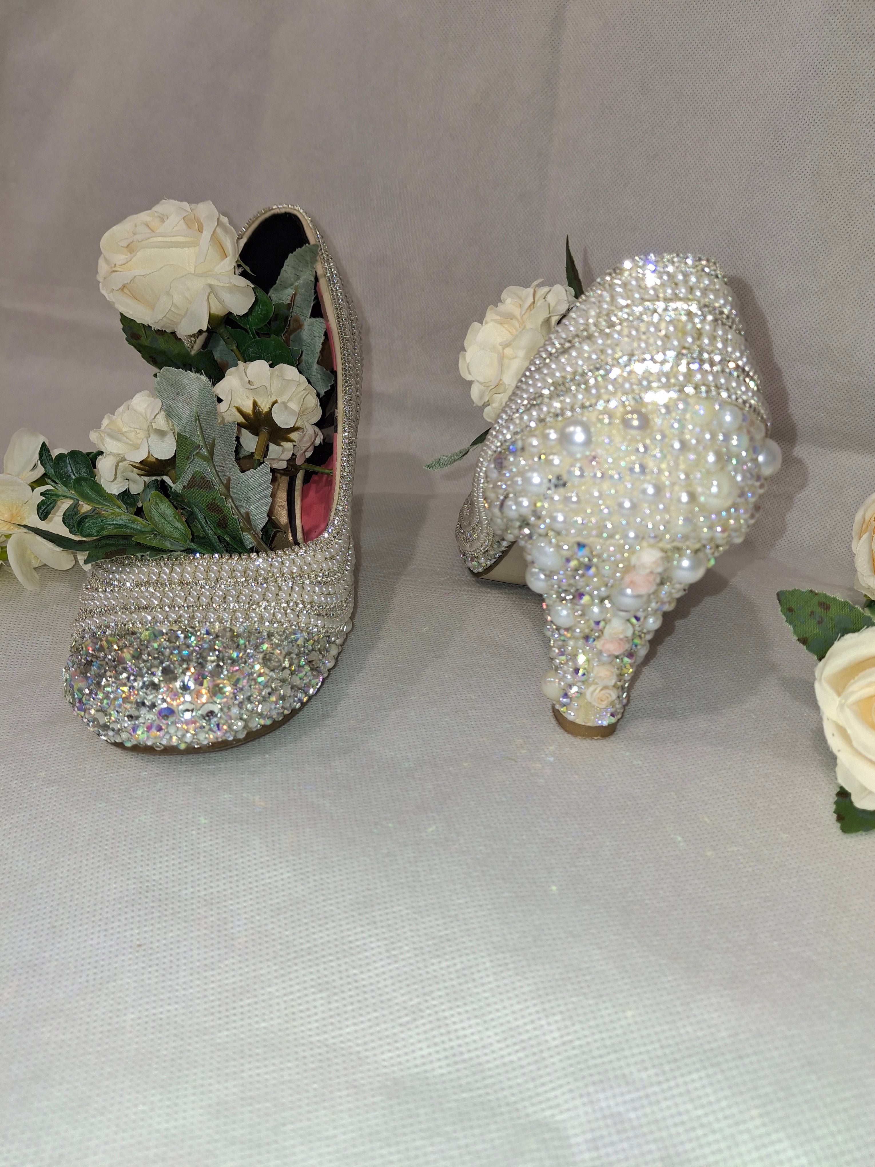 High heels with rhinestone embellishments on a white background