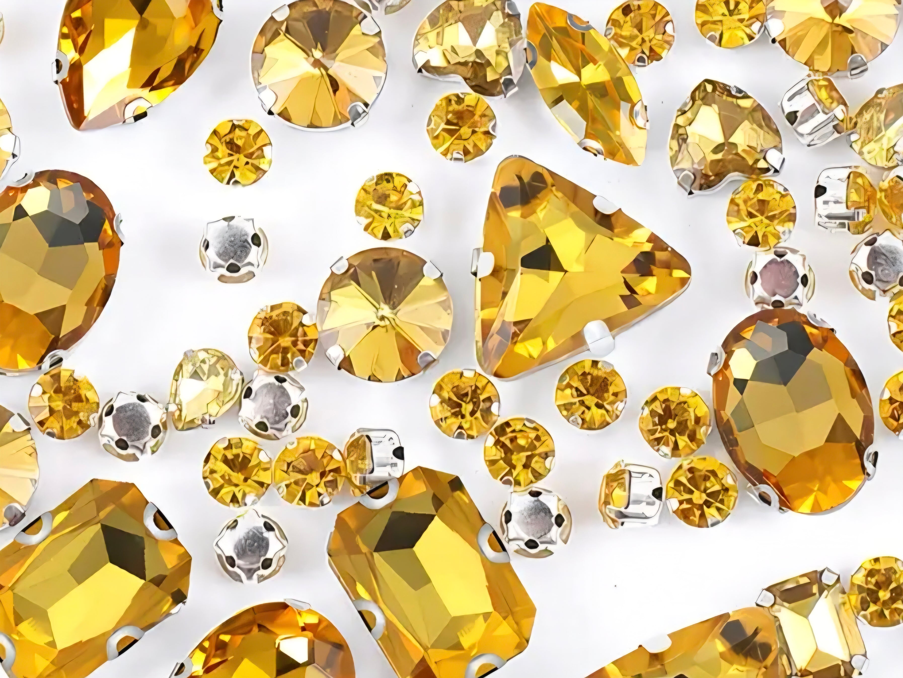Collection of yellow rhinestones on a white background