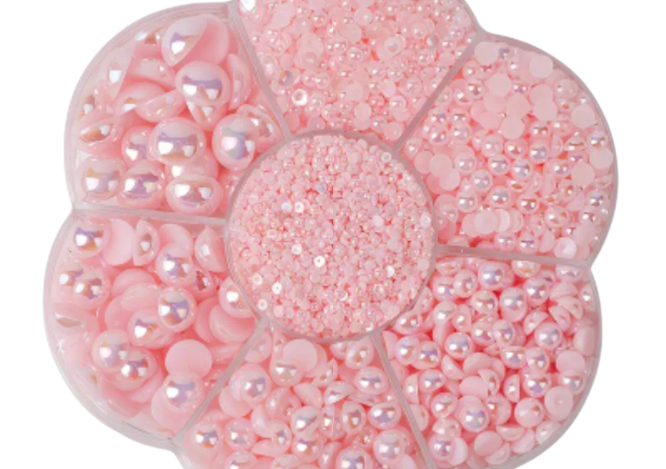 Container filled with pink pearls on a white background