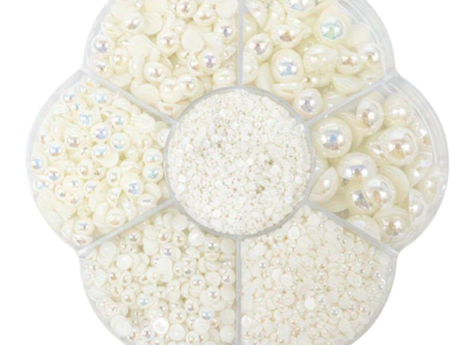 Pearl beads un a  container  on a white background