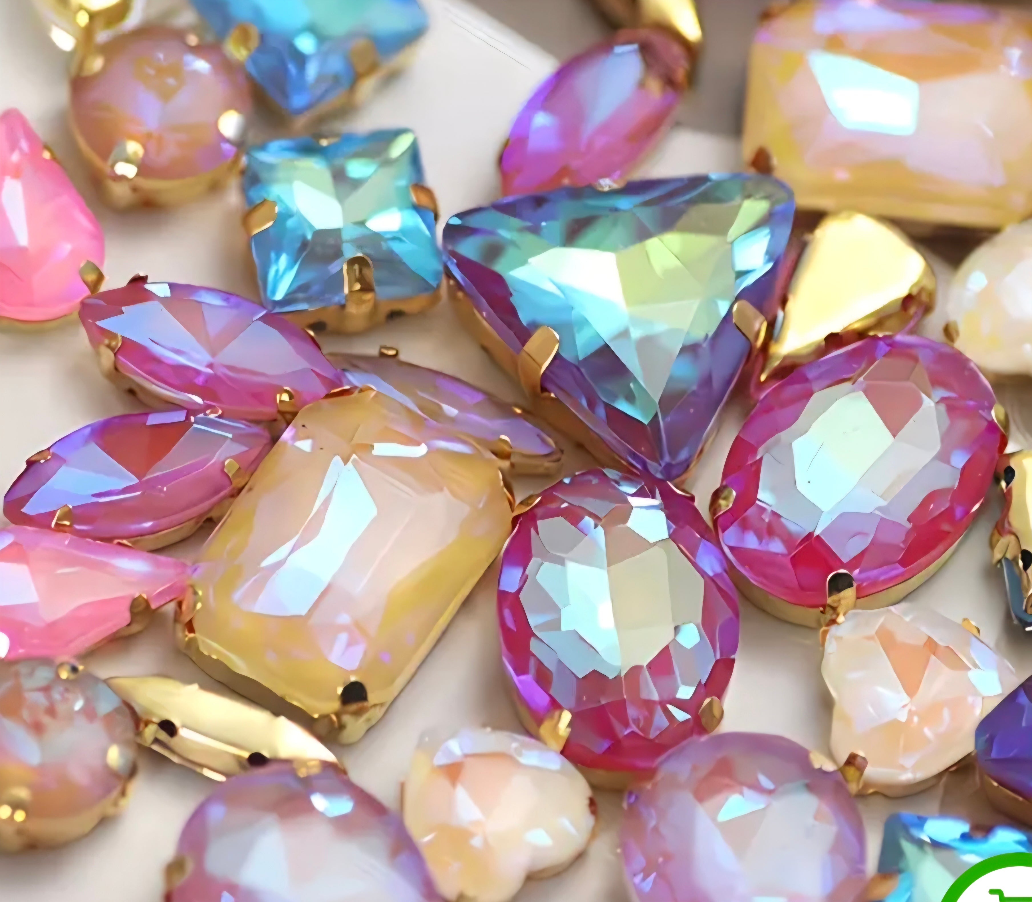 Colorful gemstones with gold settings on a white background