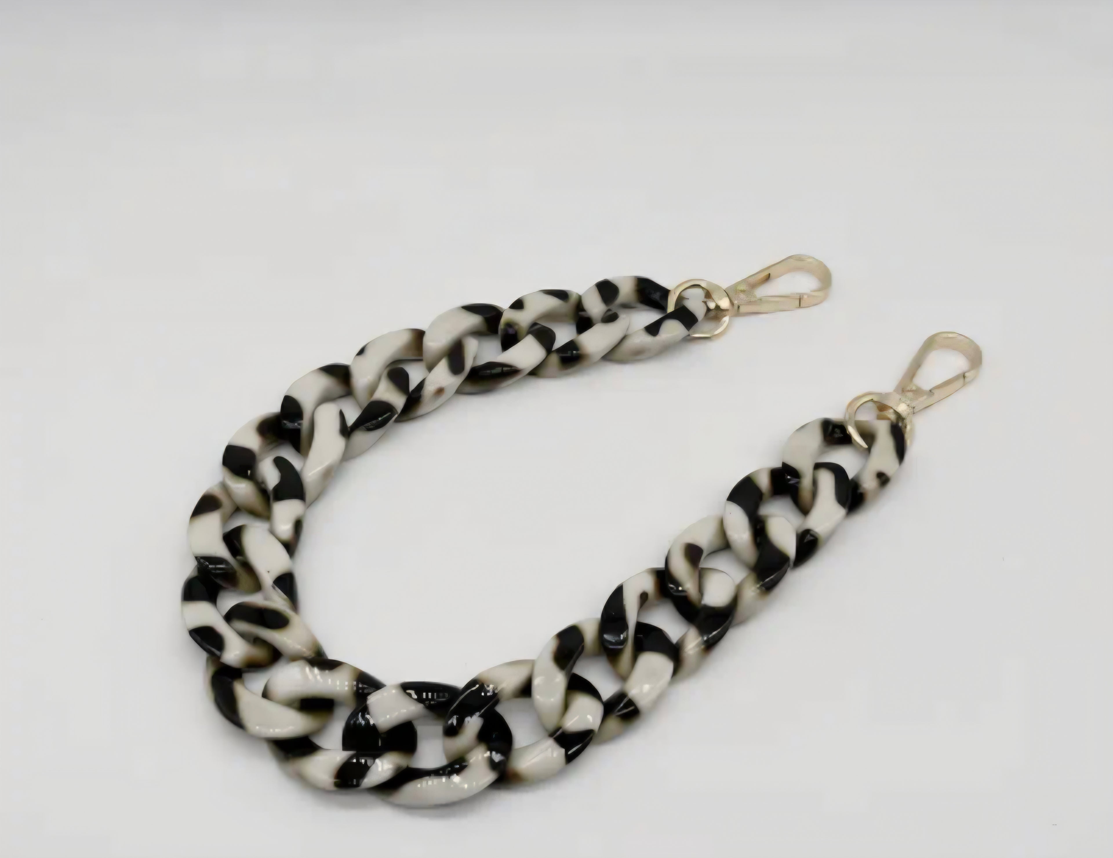Black and white acrylic purse chain o a white background. 