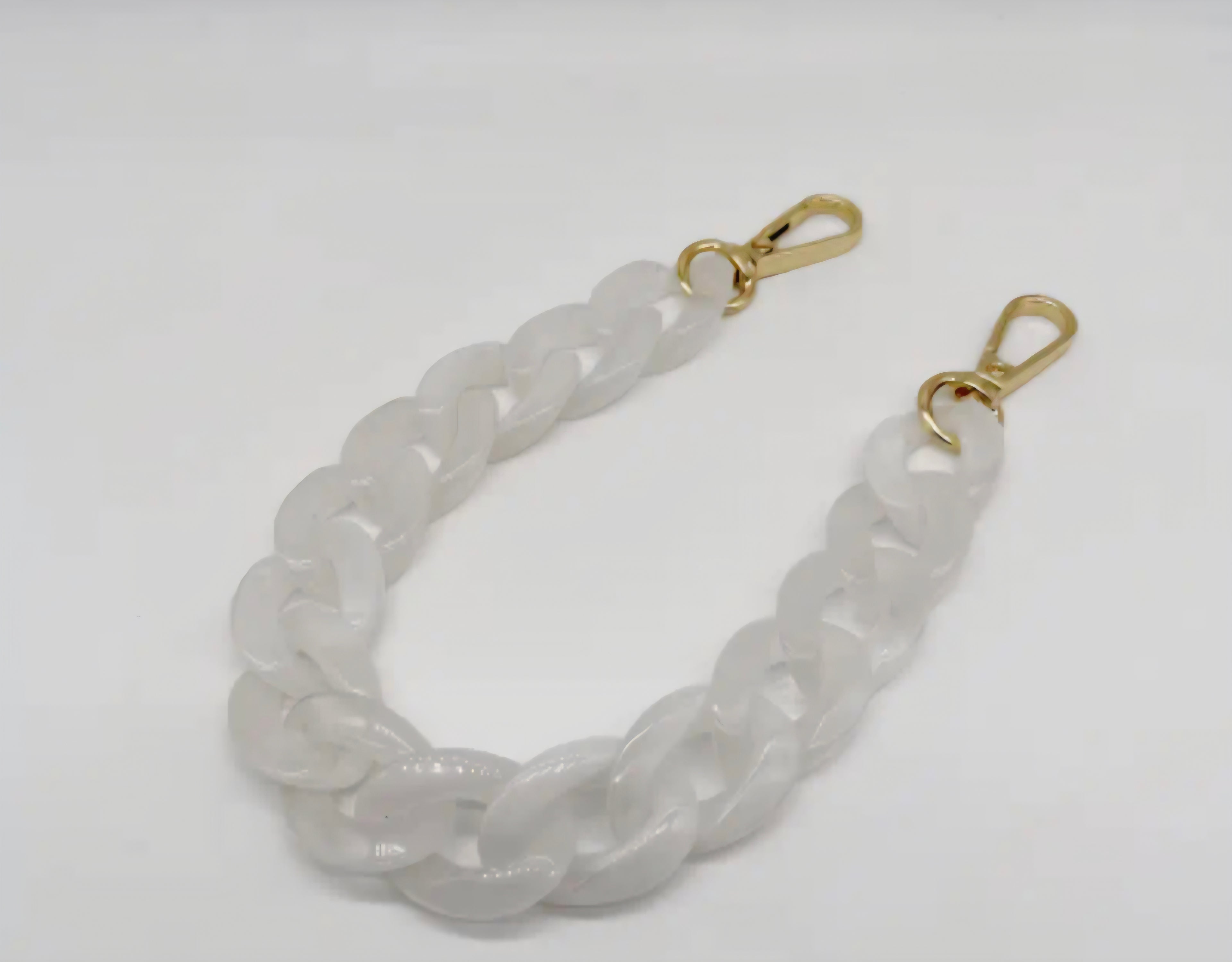 White acrylic purse chain on a white background. 