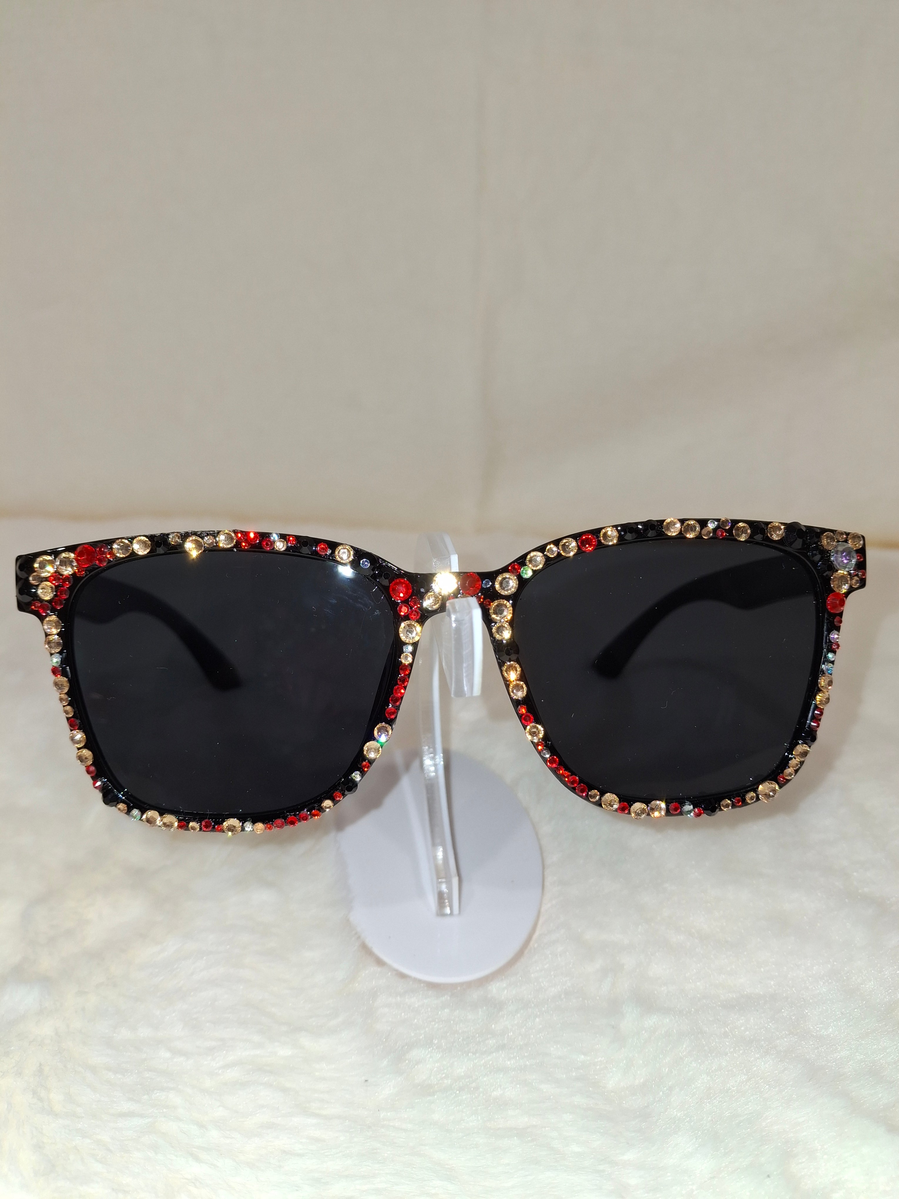 Black sunglasses with colorful gemstones on a white background