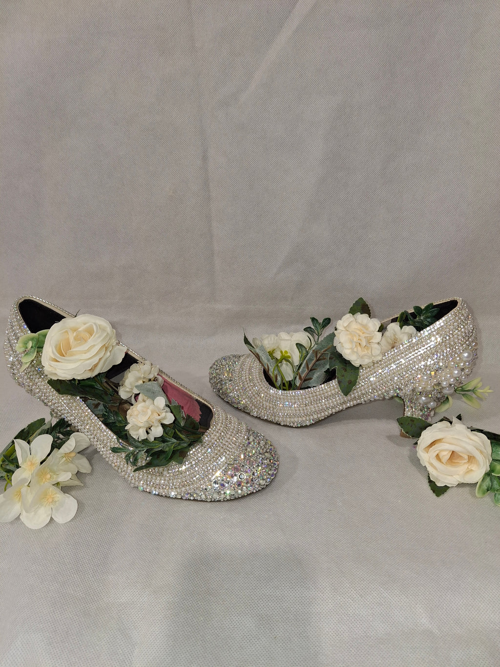 Decorative high-heeled shoes with flowers on a white background