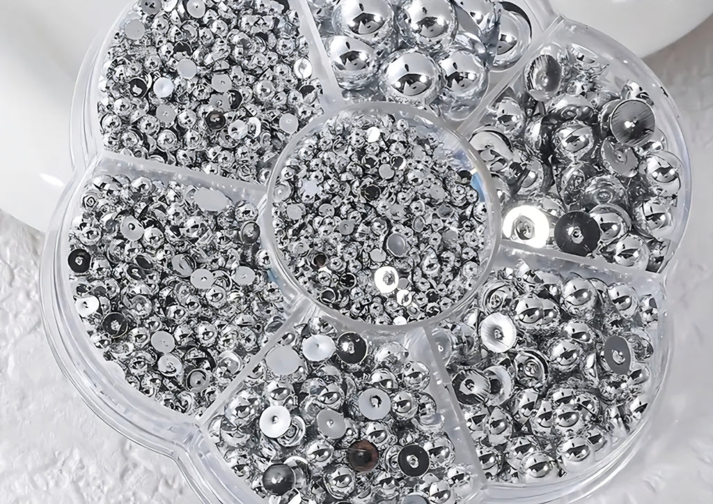 Close-up of a container filled with silver pearls for crafts