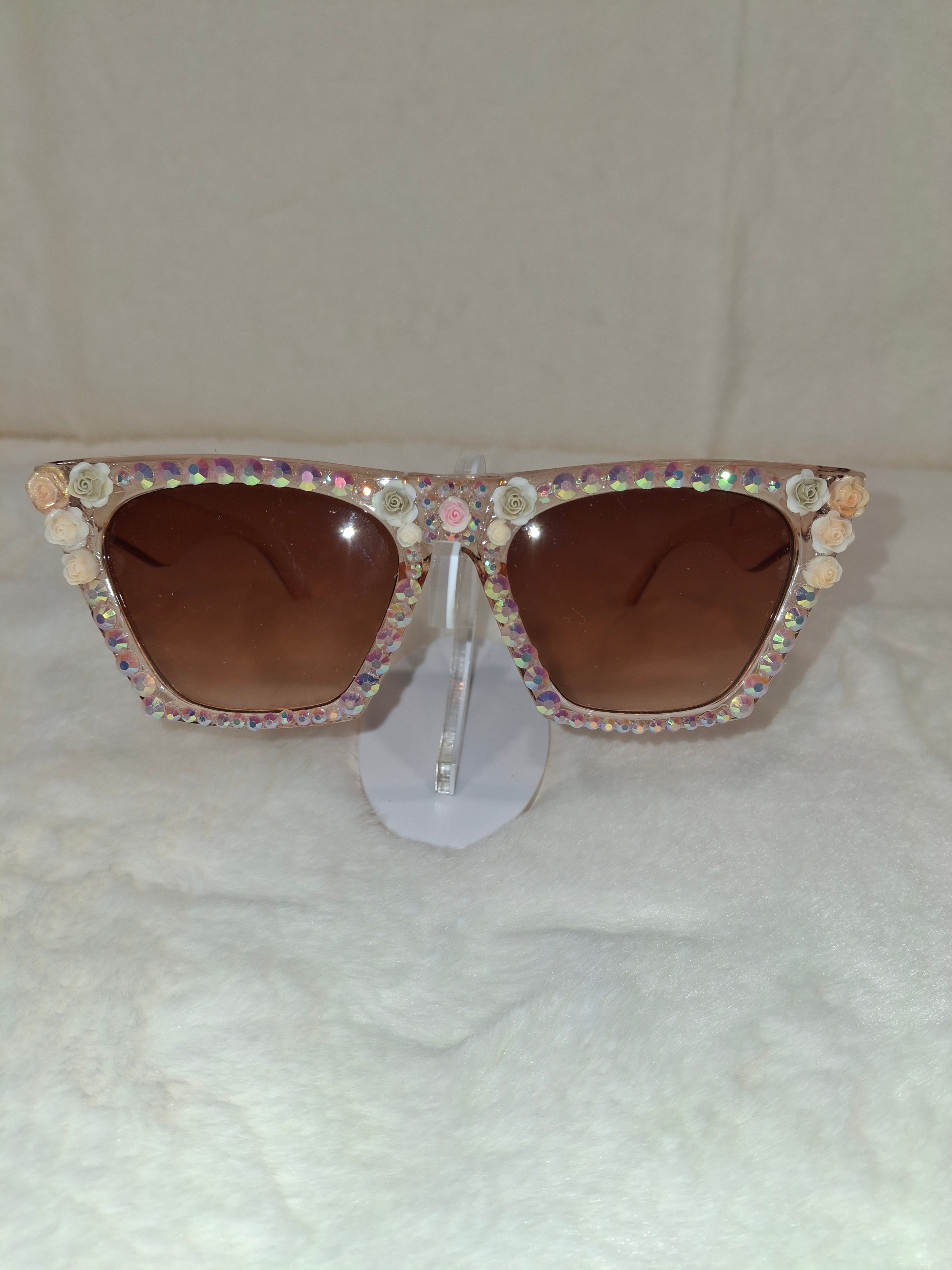 Sunglasses with decorative multicolored frame on a textured white background