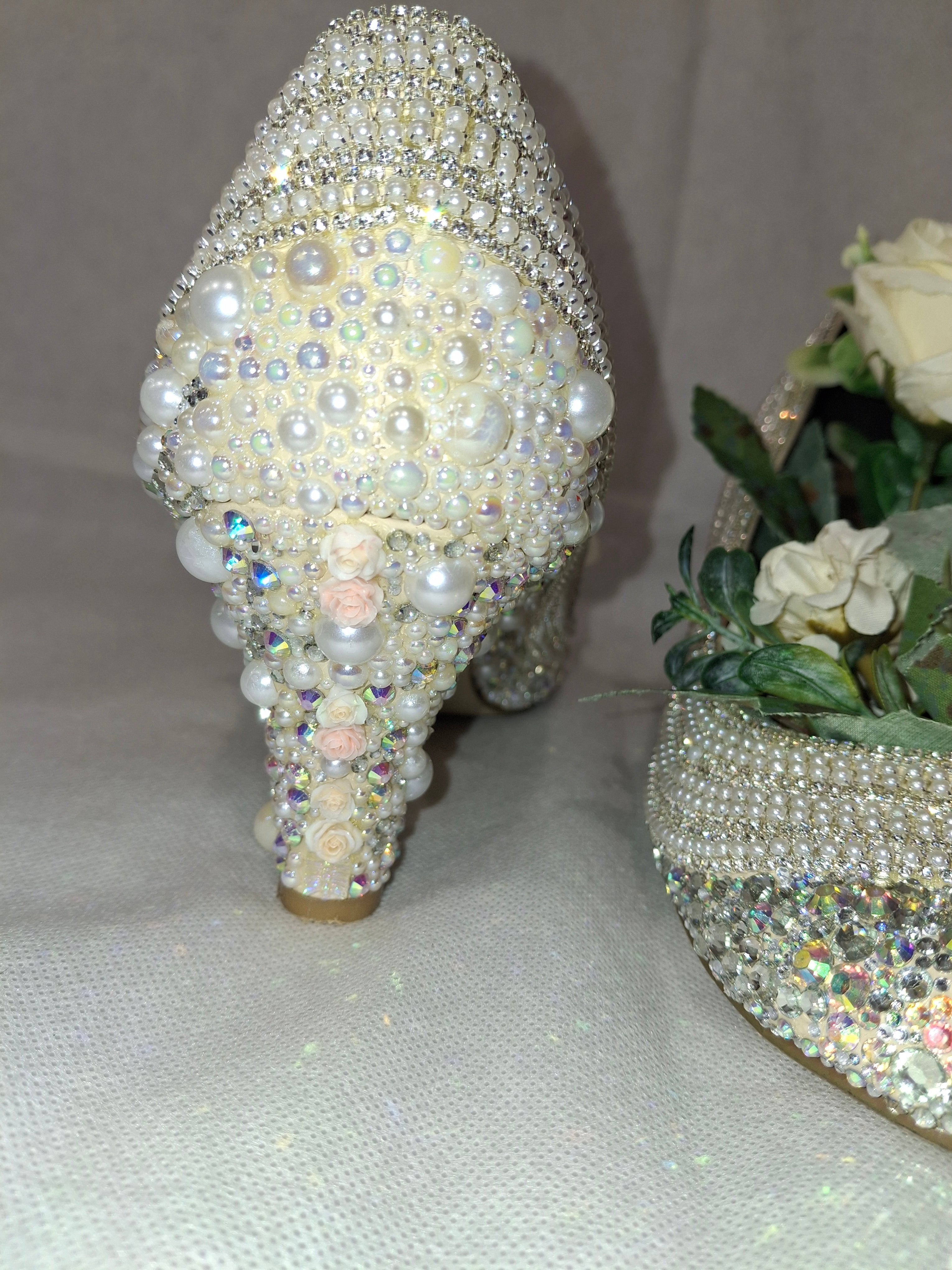 Embellished heel covered in pearls and crystals on a light background.