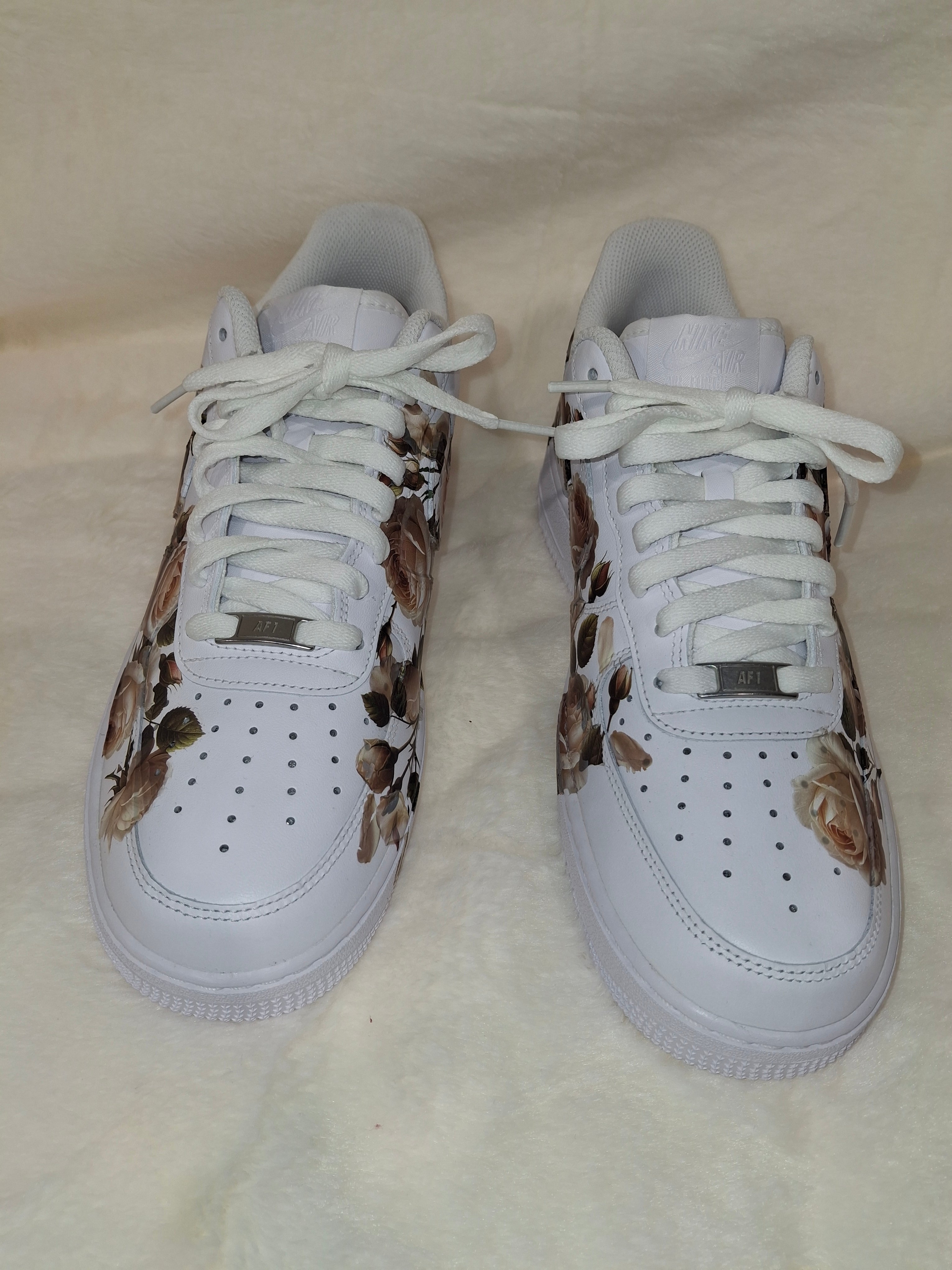 Custom white Air Force One Kids  sneakers with floral graphic design by Dressed and Done